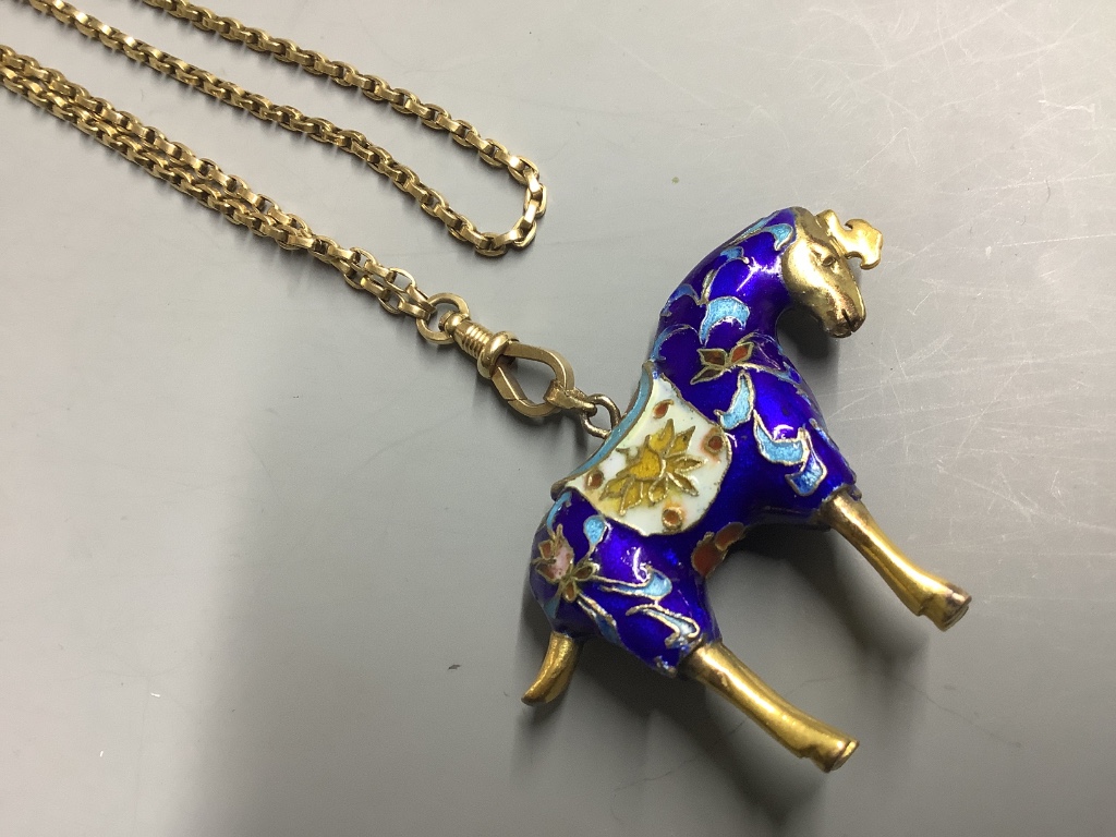 An enamelled gilt horse pendant on an unmarked yellow metal guard chain